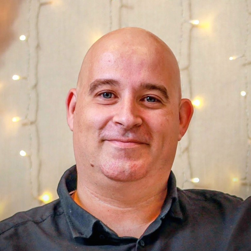 Atanas Atanasov smiling dressed in a green t-shirt